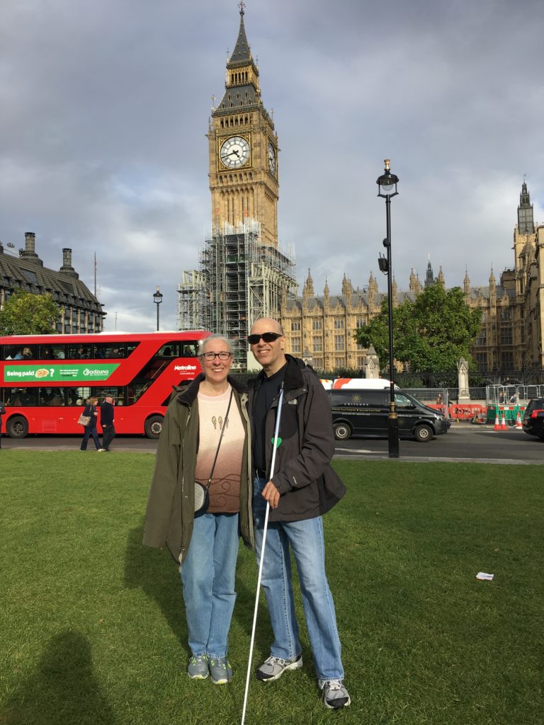Elliz and I pictured in front of Big Ben. A red double-decker bus is also behind us to the left.
