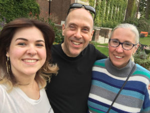 We are sitting on a bench in front of a stone building covered in ivy at Regents University London. From left to right: Jane, me, Eliz.