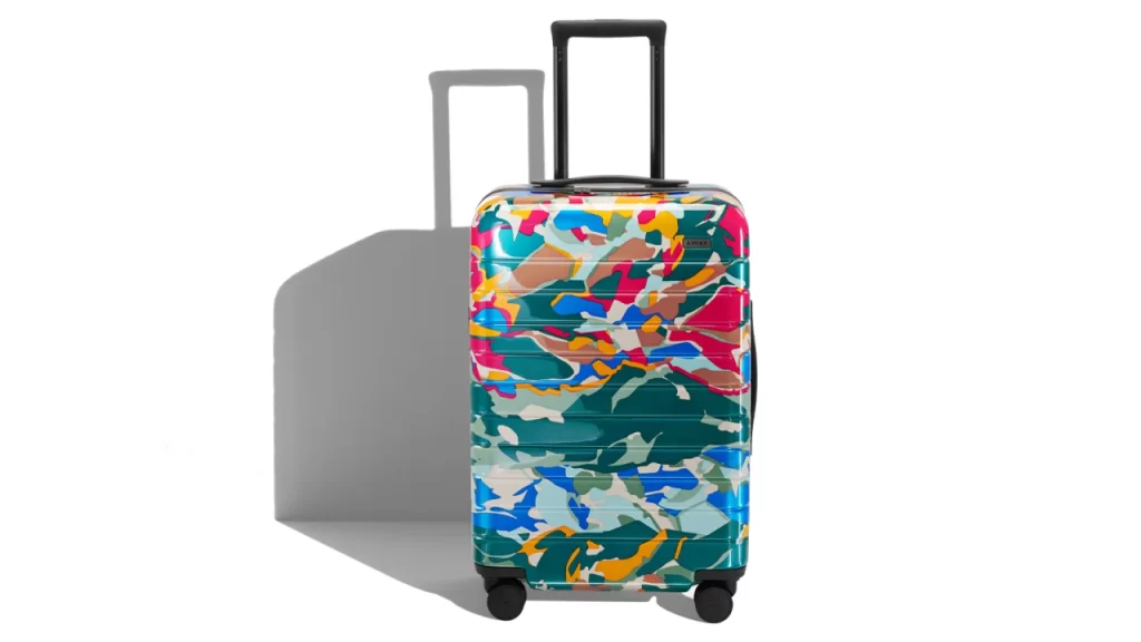 Away suitcase with a very vivid pattern on it.